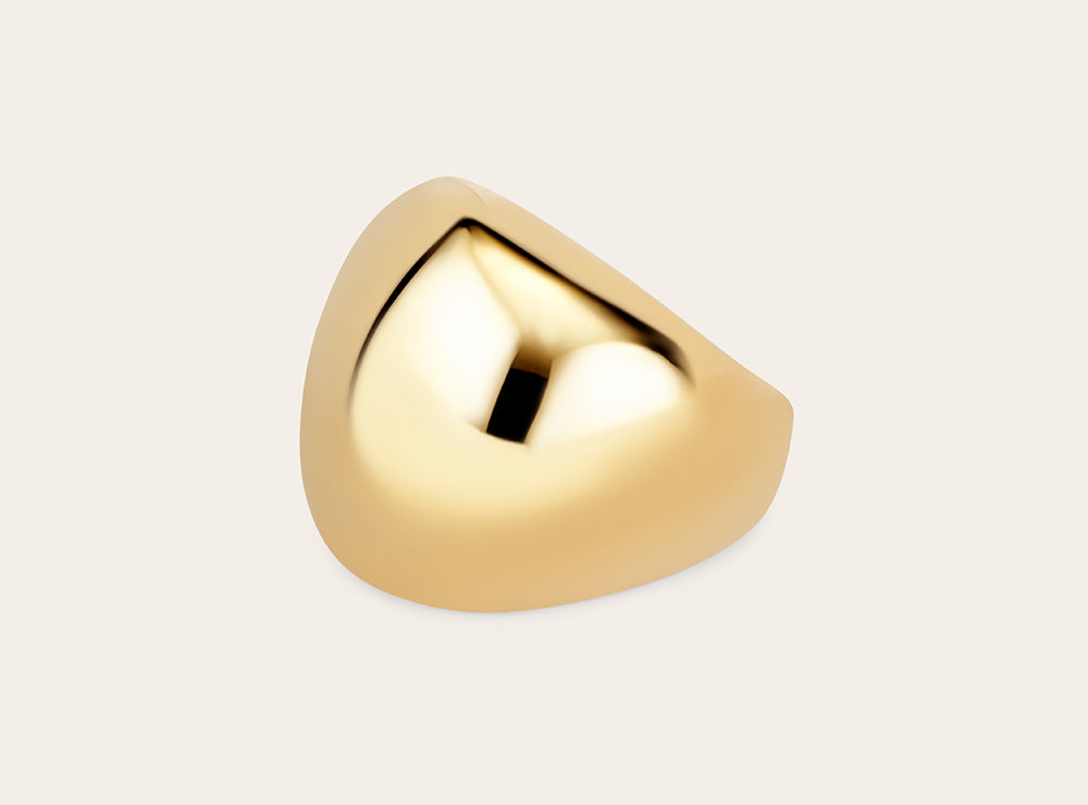 Product photo of the gold statement ring on a light background.