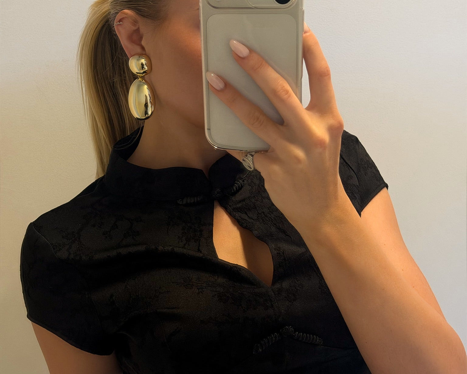 Model wearing gold plated drop earrings