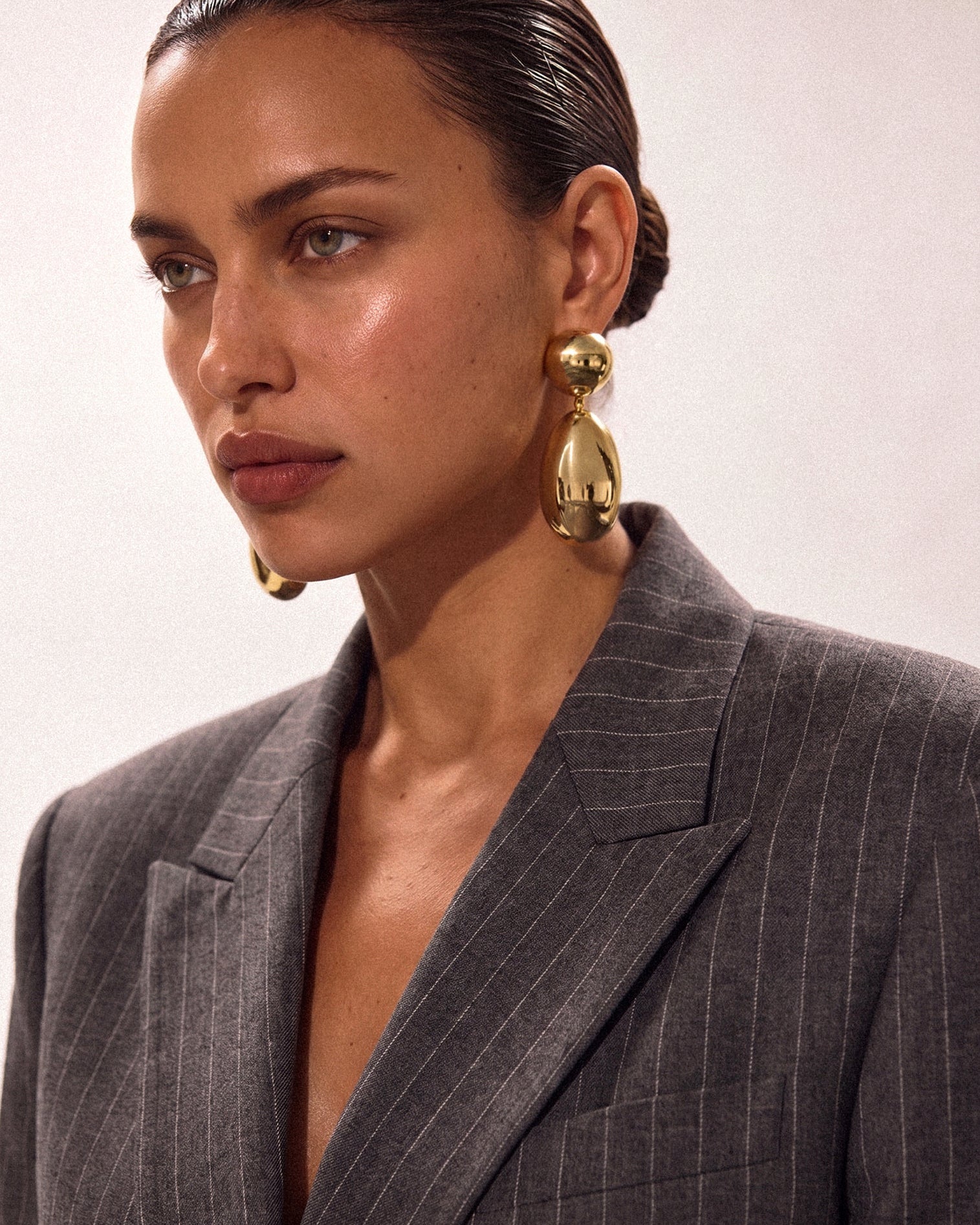 Model wearing gold plated oval earrings