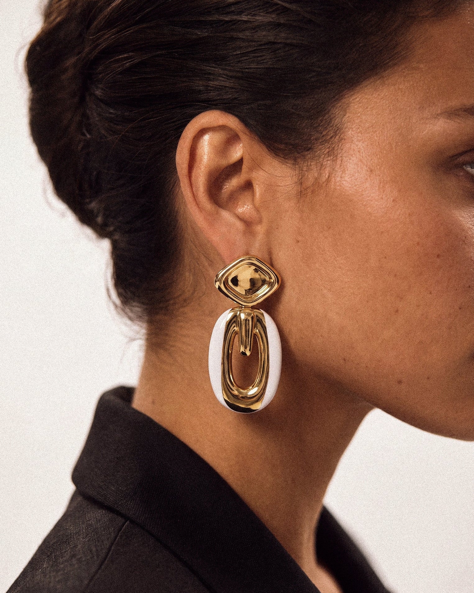 Model wearing gold plated drop earrings