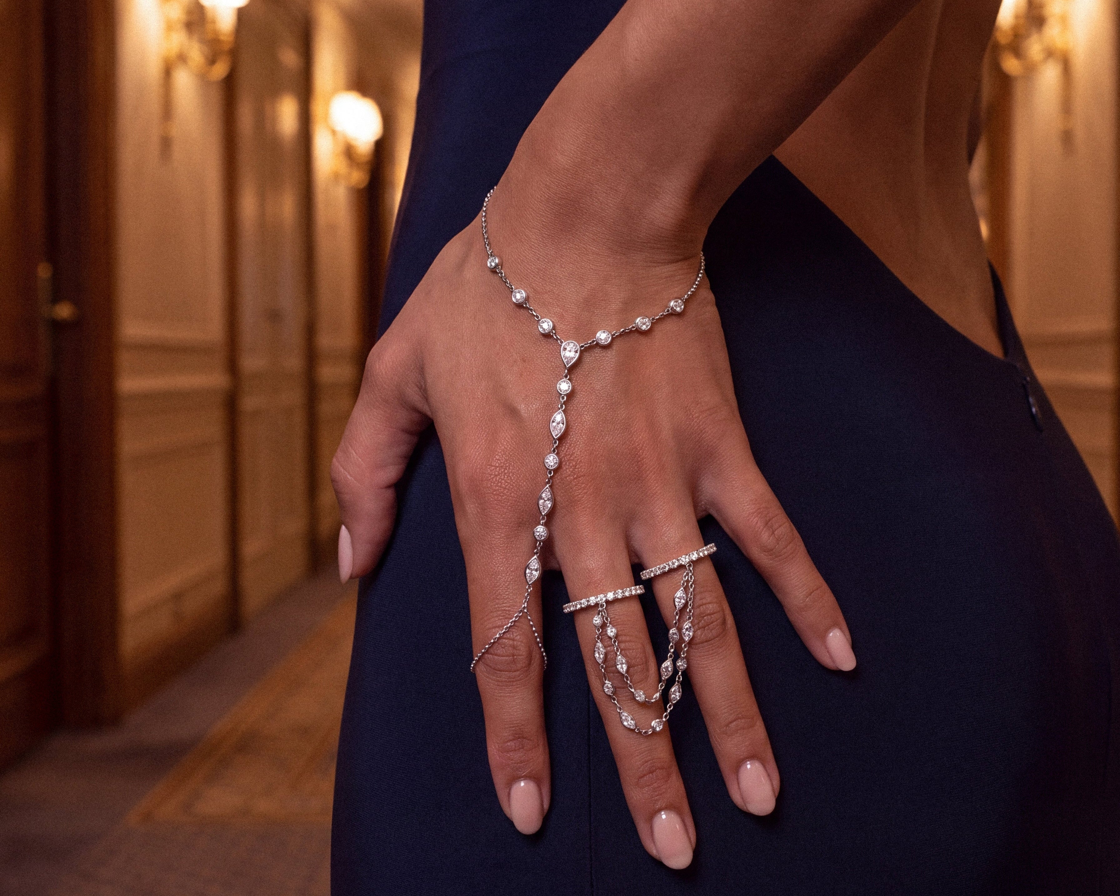 Model wearing a silver double chain ring with a dark blue dress