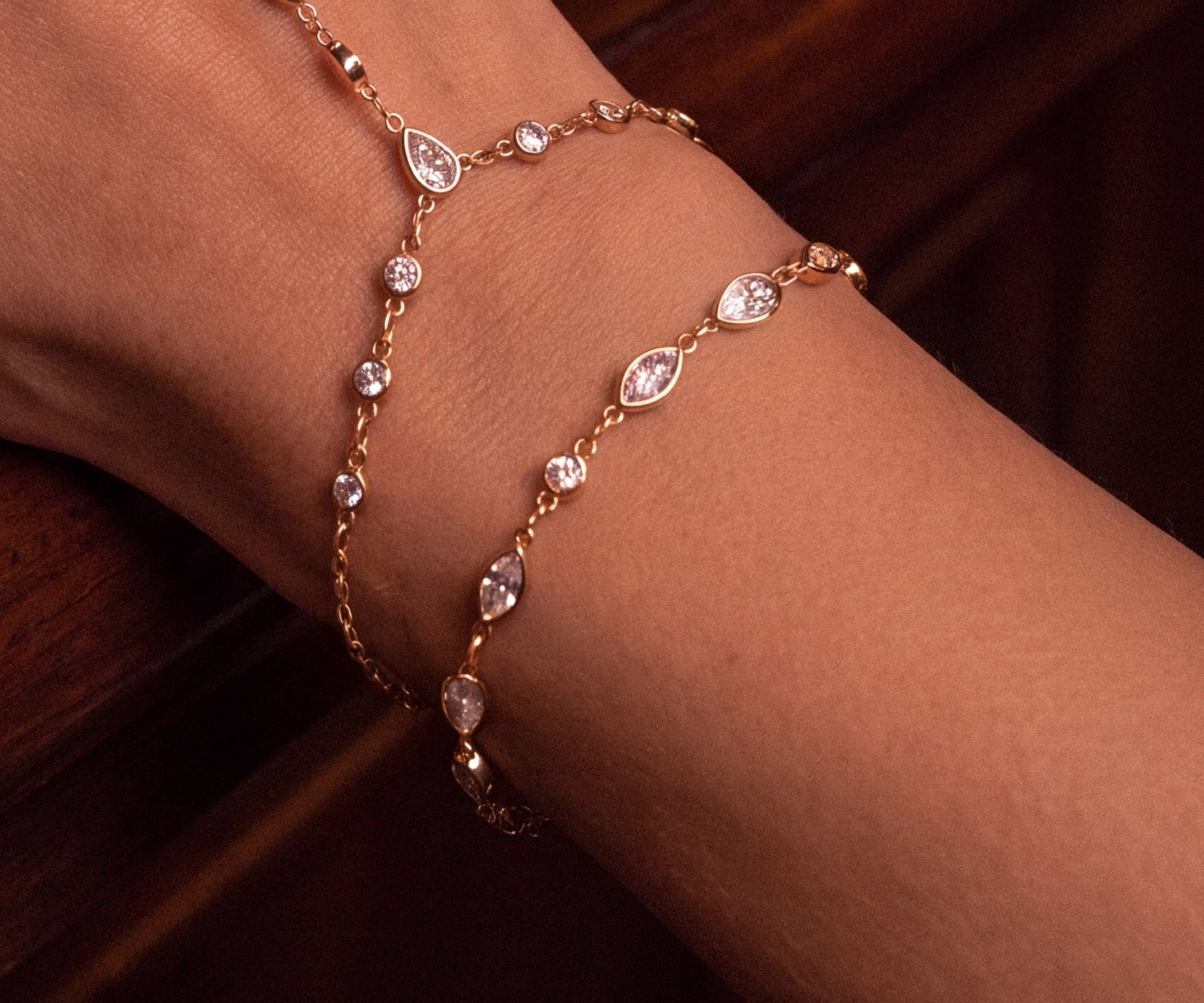 Gold crystal bracelet worn on wrist, close-up.